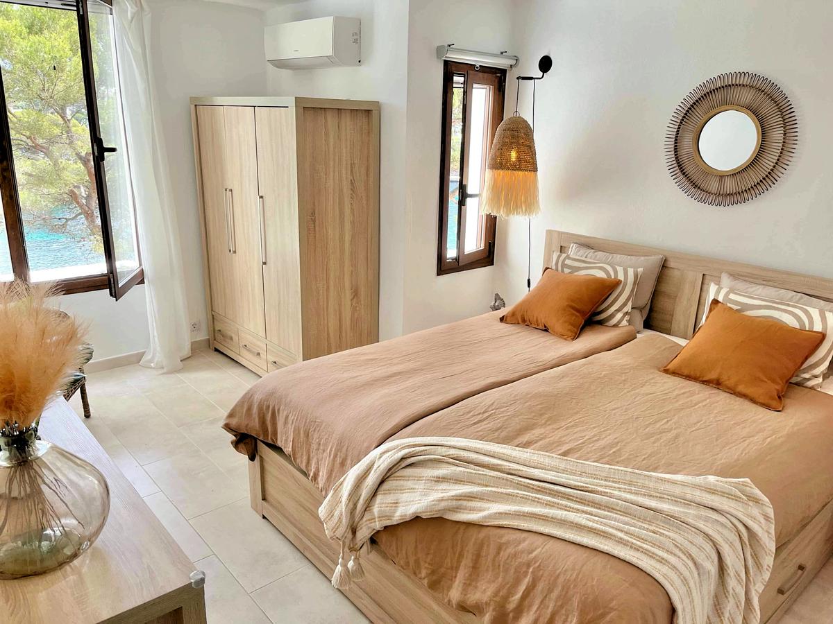 Från master bedroom skymtar man Cala Ferrera mellan pinjeträden